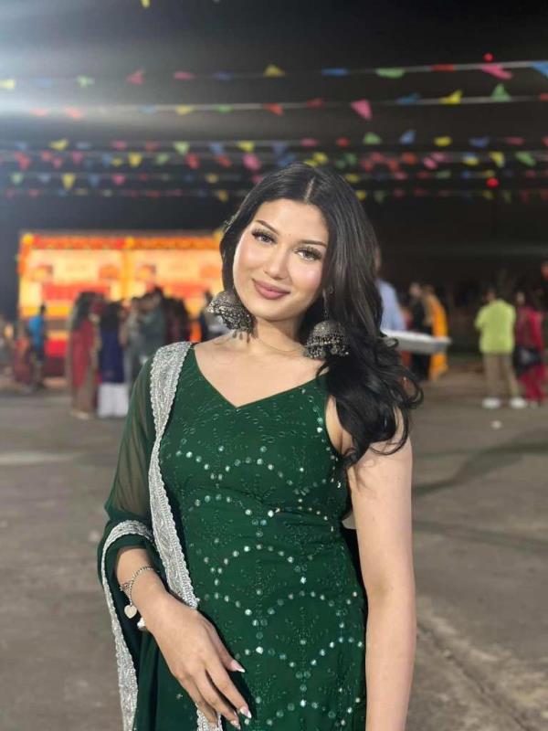 Muna Pandey in a green dress